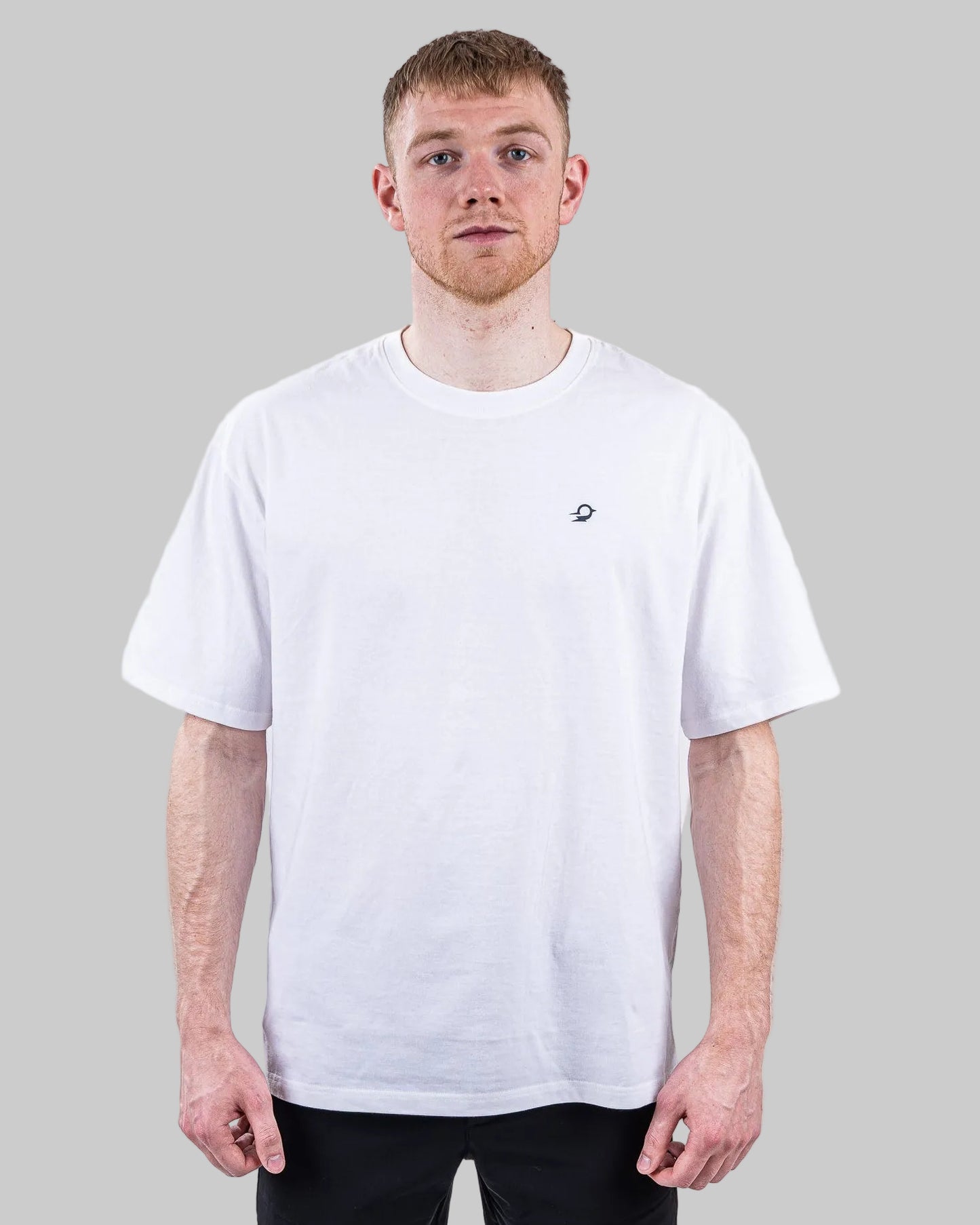 Person wearing a white t-shirt and black pants on a white background