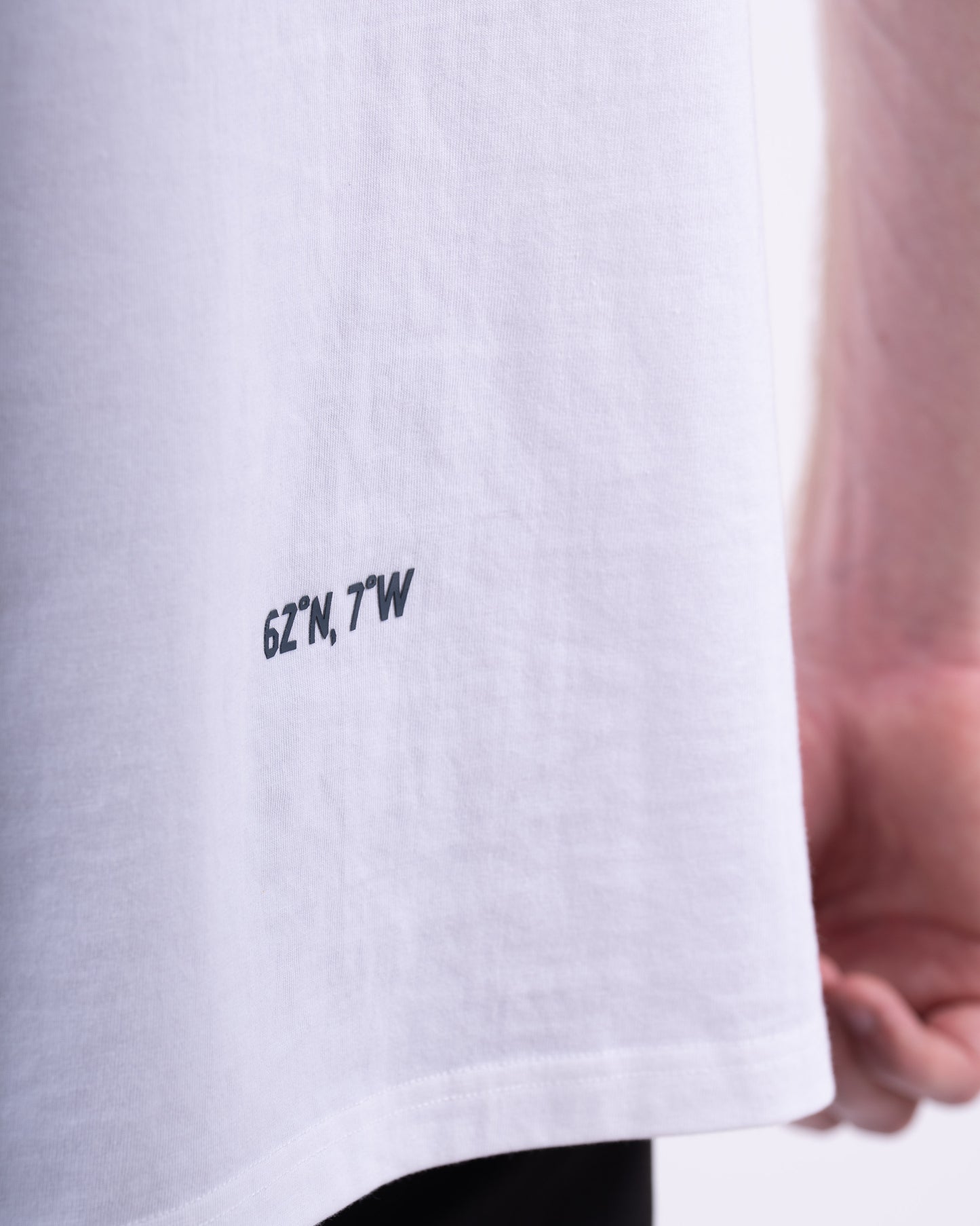 White t-shirt with black text on a white background